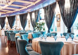 restaurant-hall-with-blue-chairs-blue-glasses-table_140725-8027
