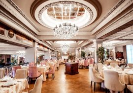 restaurant-hall-with-round-square-tables-some-chairs-plants_140725-8030